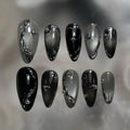 STORESDE 24Pcs Black Y2k Long False Nails with Almond Head Design Cat's Eye Silver Stripe Pattern Press on Fake Nails Wearable Nail Tips